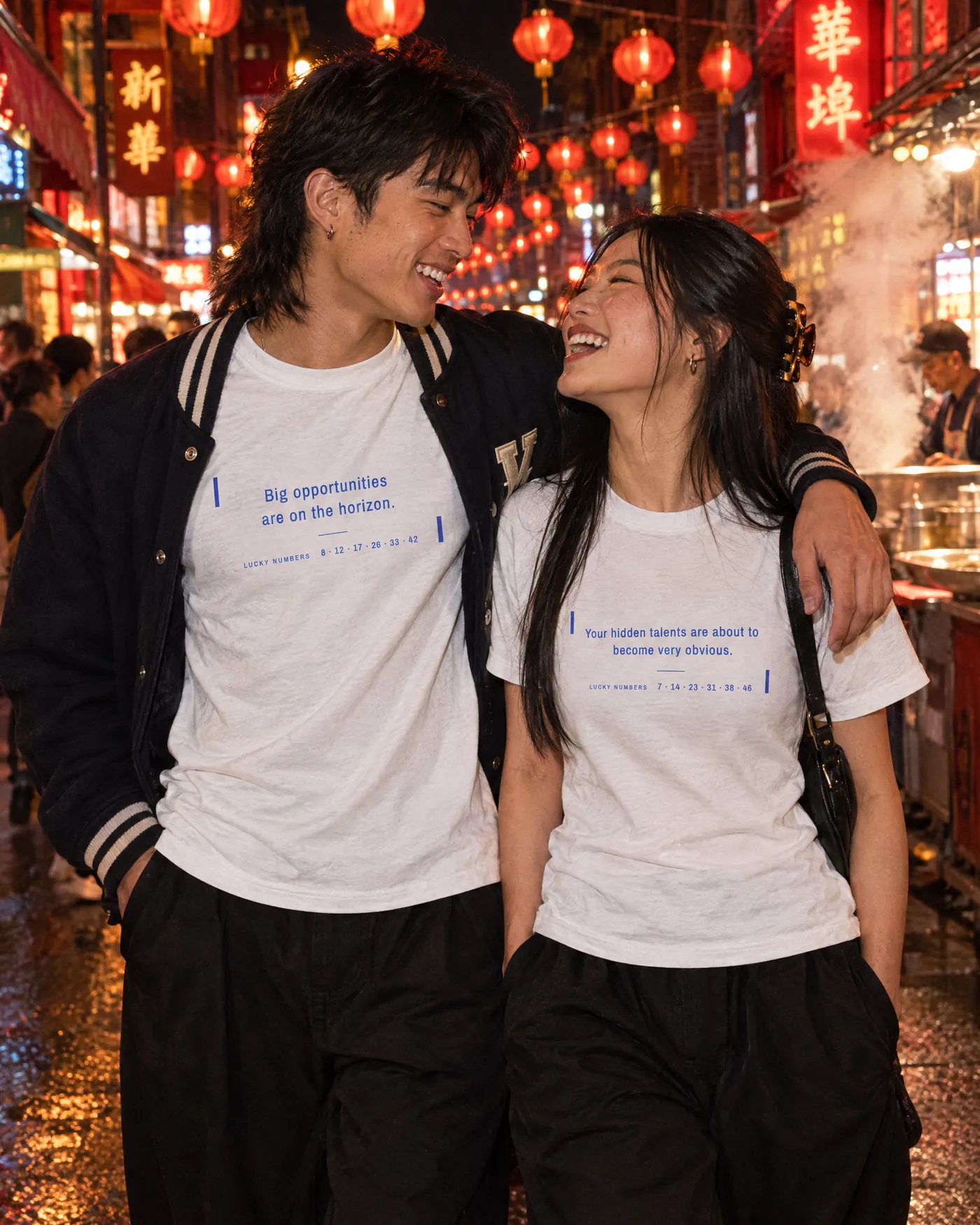 Couple in matching Fortune Cookie Shirts laughing under red lanterns in Chinatown